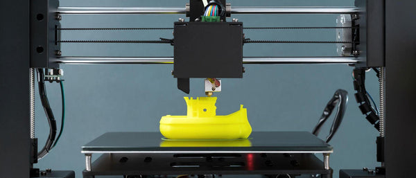 a 3d printer printing a toy submarine