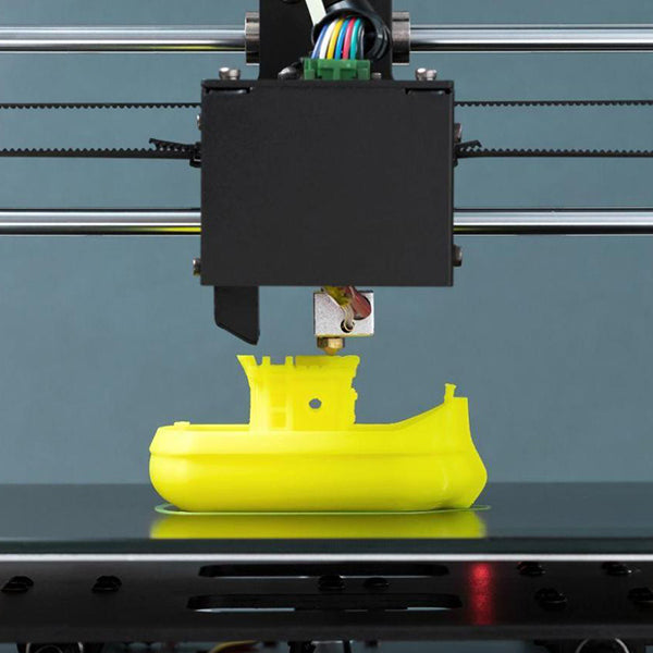 a 3d printer printing a toy submarine