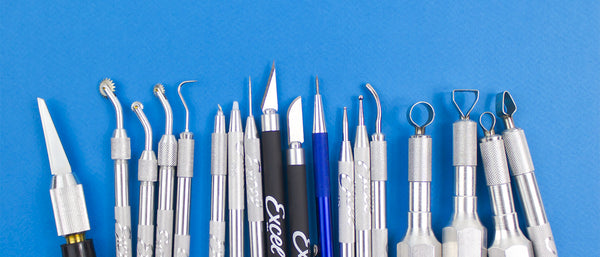 an assortment of clay sculpting tools against a blue background