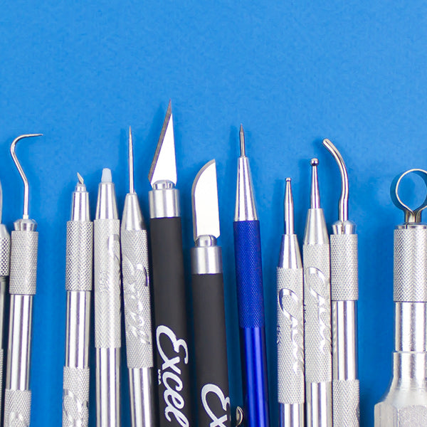 an assortment of clay sculpting tools against a blue background