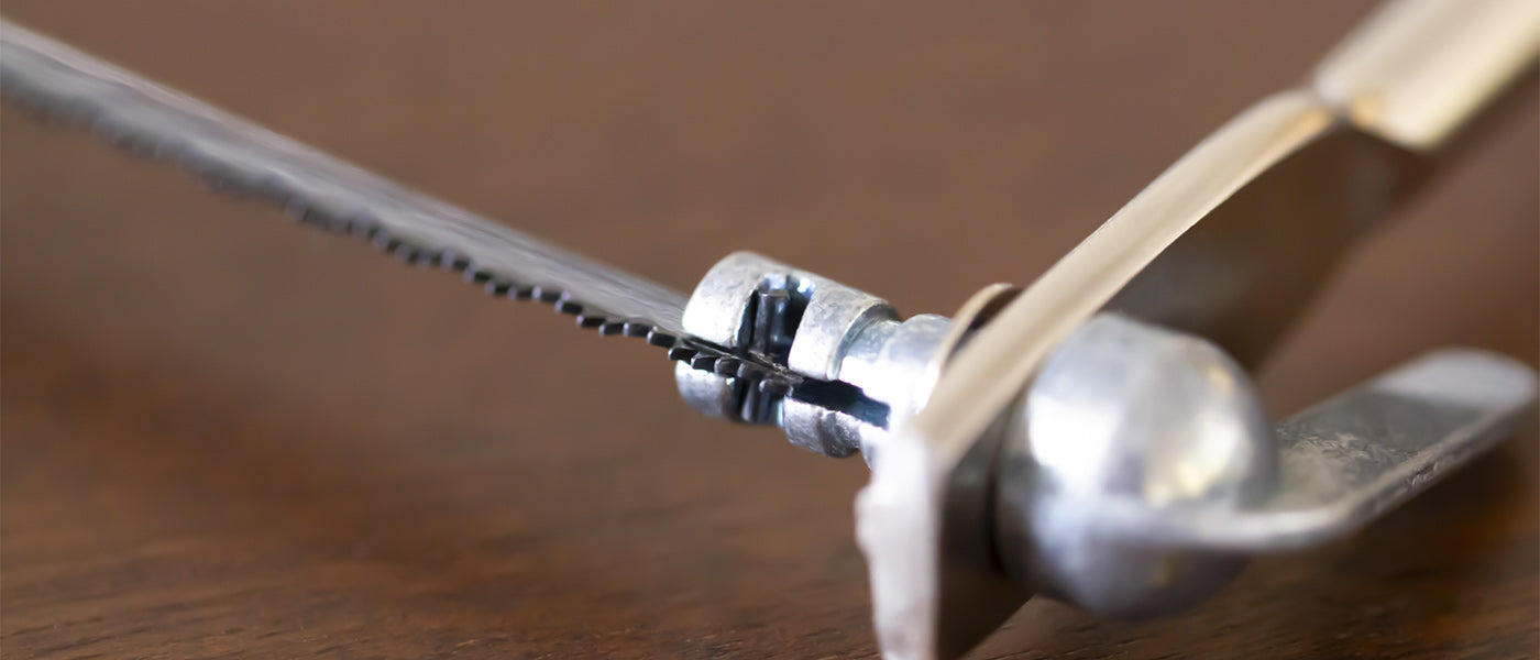 a close up of the top arm of a coping saw