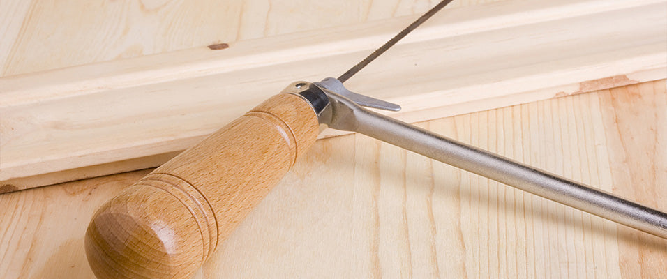 coping saw on piece of wood