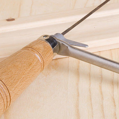 coping saw on piece of wood
