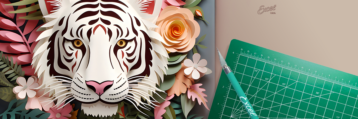Kirigami tiger and flowers next to an Excel Blades craft knife and self-healing cutting mat.