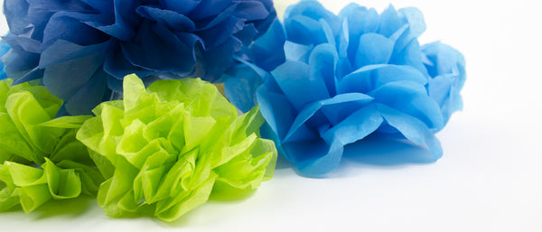 a pile of tissue paper flowers in green and blue