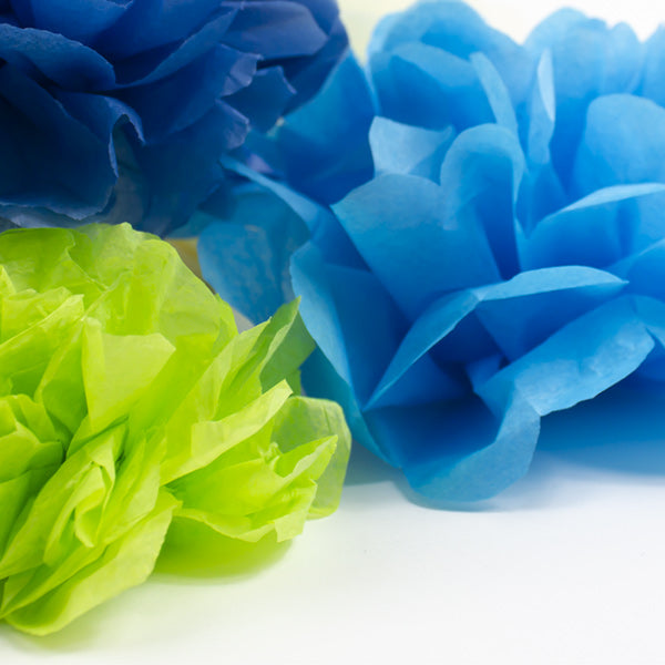 a pile of tissue paper flowers in green and blue