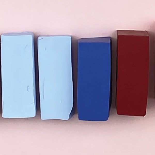 a line of different colored polymer clay blocks