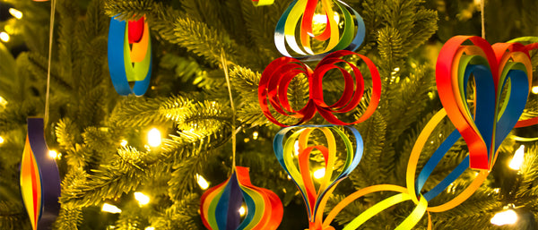 various multi-colored paper ornaments hanging on a tree