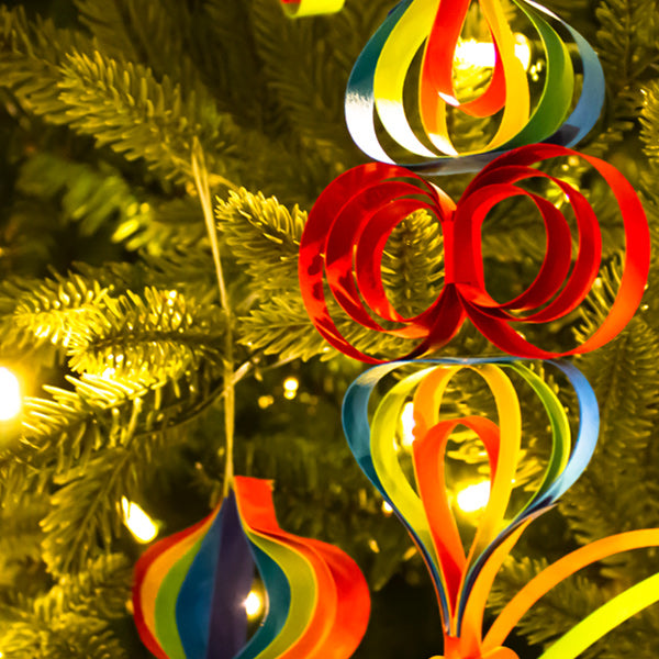 various multi-colored paper ornaments hanging on a tree